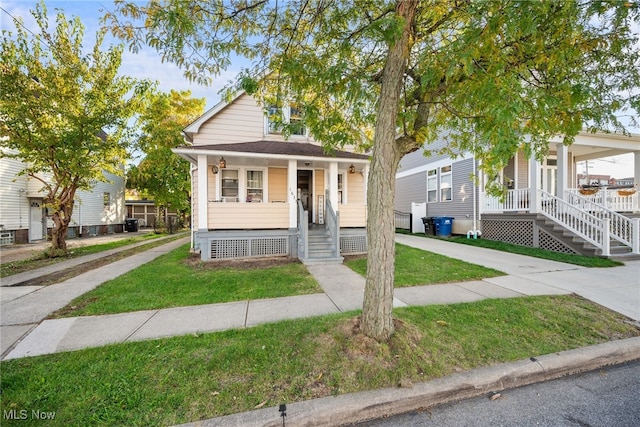 view of front facade with a front lawn and a porch