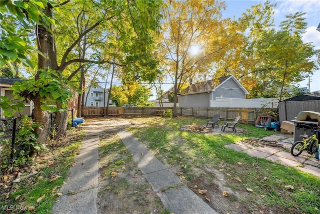 view of yard with a patio and a fire pit