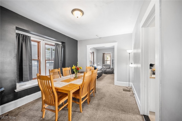 dining space featuring carpet flooring