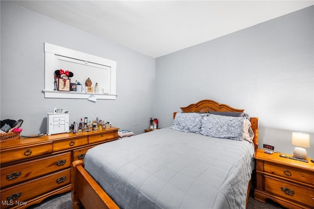 bedroom with dark colored carpet