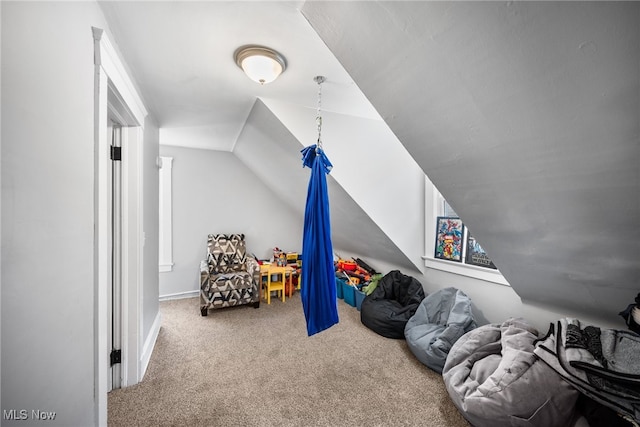 playroom with vaulted ceiling and carpet flooring