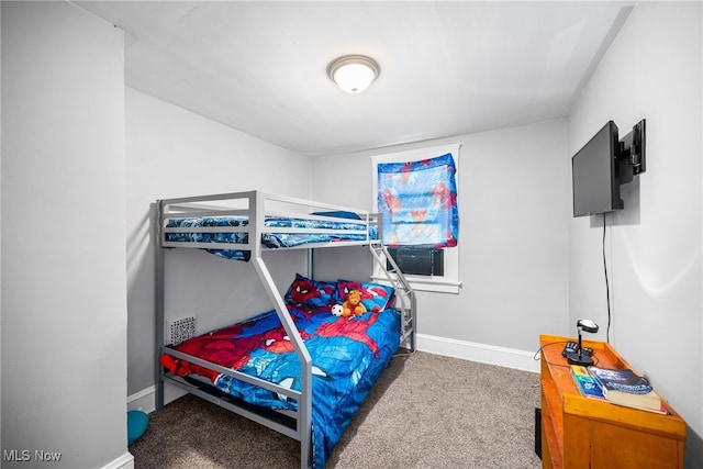 bedroom with dark colored carpet