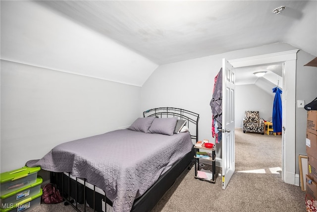 bedroom with vaulted ceiling and carpet flooring