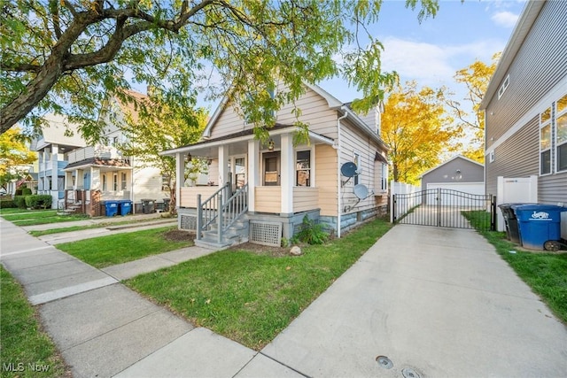 1633 Hopkins Ave, Lakewood, OH 44107 - view of front of property featuring a front yard, a garage, a porch, and a gate
