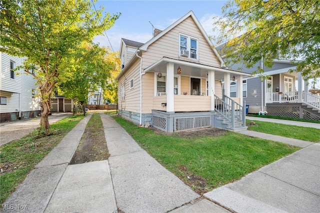 bungalow-style house with a front yard and a porch