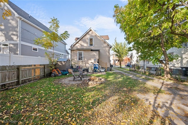 back of property with a yard and a patio