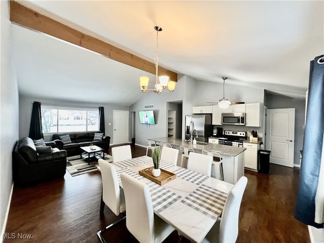 dining room with sink, dark wood-type flooring, high vaulted ceiling, and ceiling fan with notable chandelier