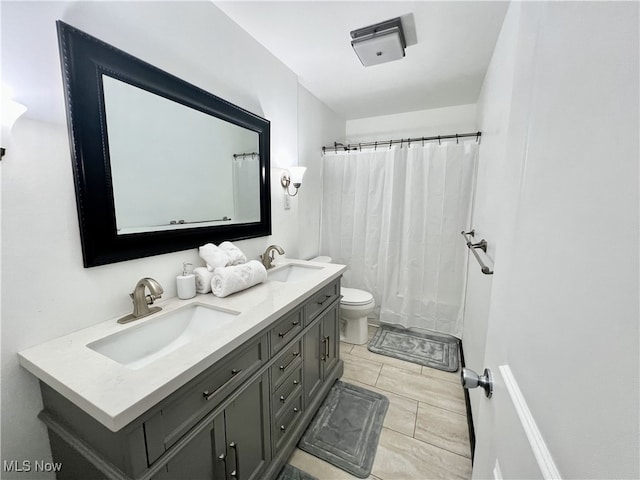 bathroom with toilet, walk in shower, vanity, and tile patterned floors