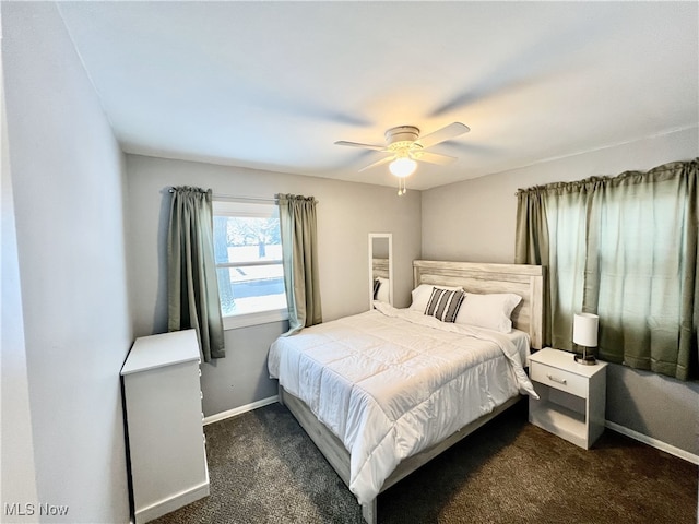 bedroom with dark carpet and ceiling fan