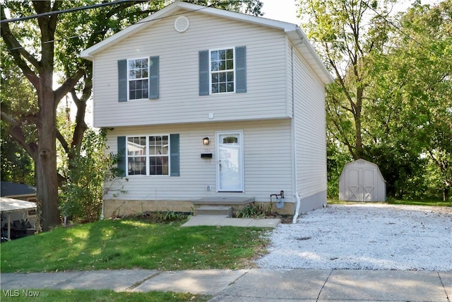 view of front of house with a storage unit and a front yard