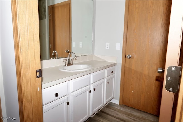 bathroom featuring vanity and hardwood / wood-style floors