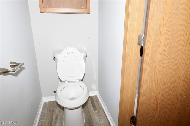 bathroom with toilet and hardwood / wood-style flooring