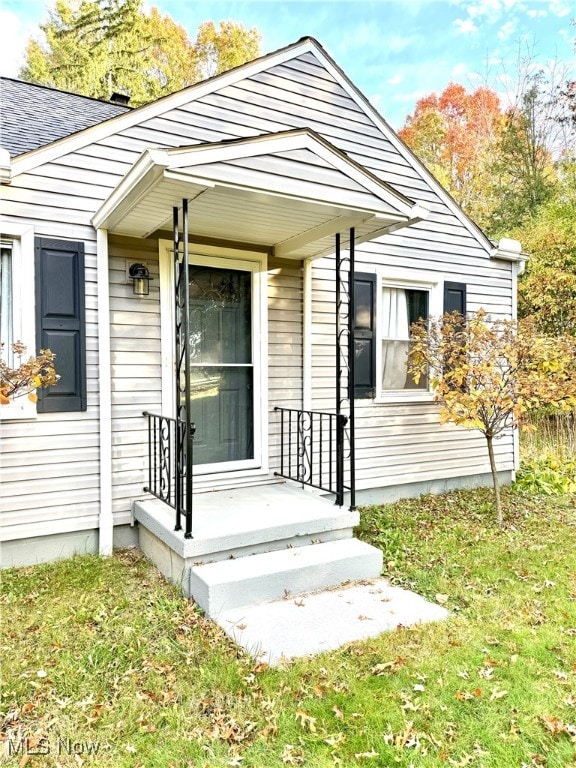 property entrance with a yard