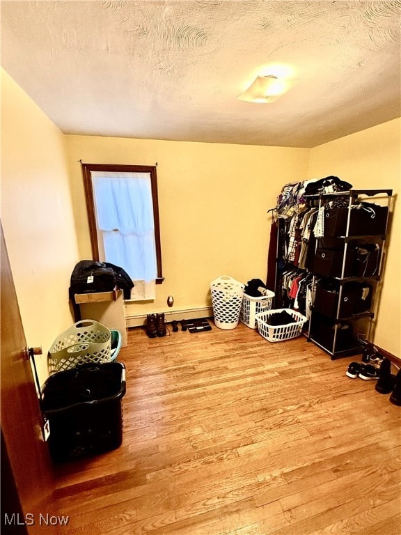 misc room with hardwood / wood-style floors and a textured ceiling