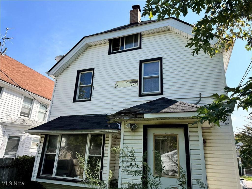 rear view of property with a chimney