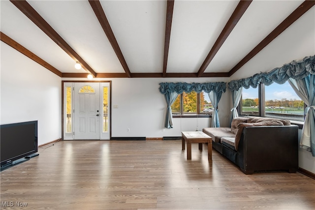 living room featuring hardwood / wood-style floors and lofted ceiling with beams