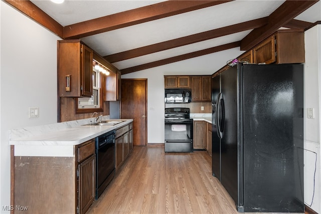 kitchen with sink, black appliances, lofted ceiling with beams, and light hardwood / wood-style flooring