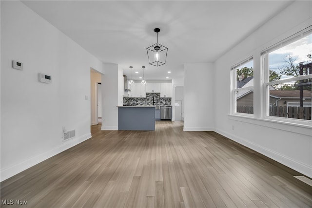 unfurnished living room with hardwood / wood-style floors