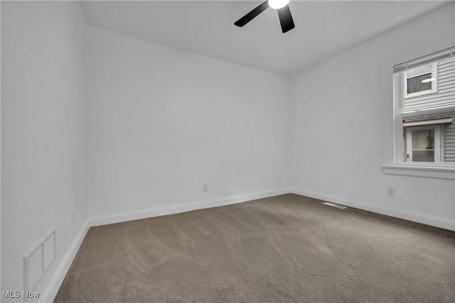 unfurnished room featuring ceiling fan and carpet floors