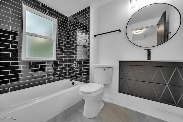 full bathroom with tiled shower / bath combo, toilet, and vanity