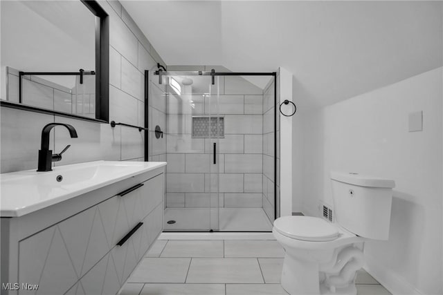 bathroom with tile patterned flooring, vanity, toilet, and a shower with door