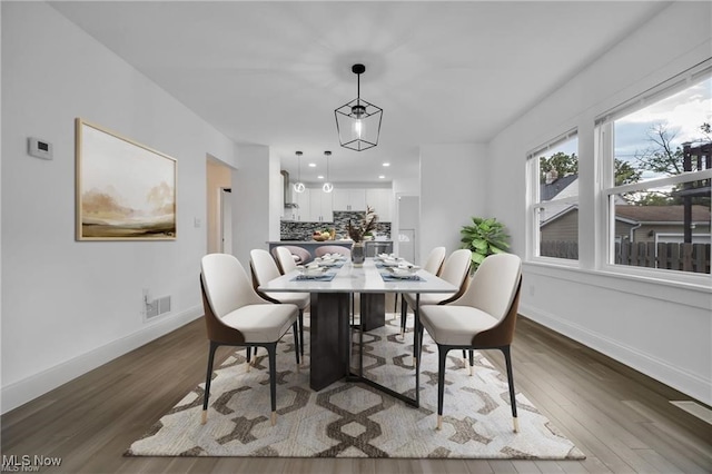 dining room with dark wood-type flooring