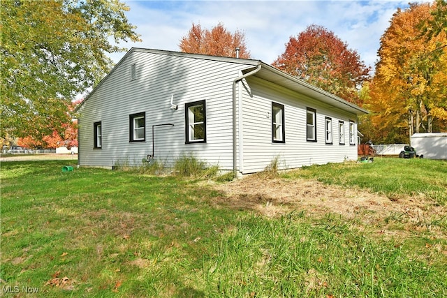 view of side of home featuring a lawn