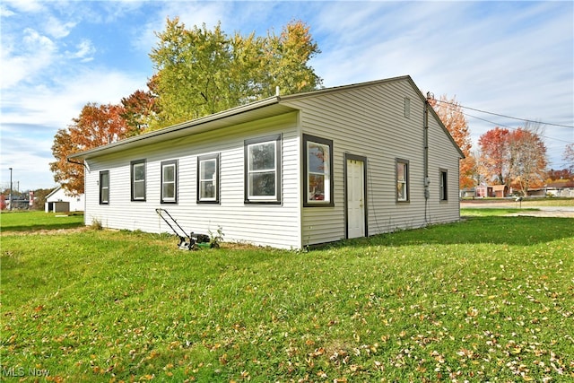 view of side of property with a yard