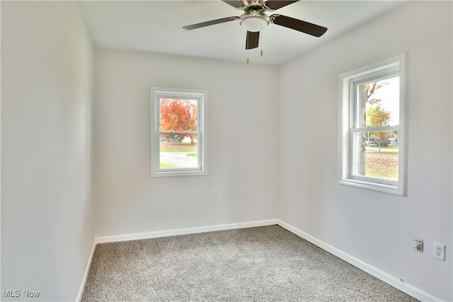 empty room featuring carpet floors and ceiling fan