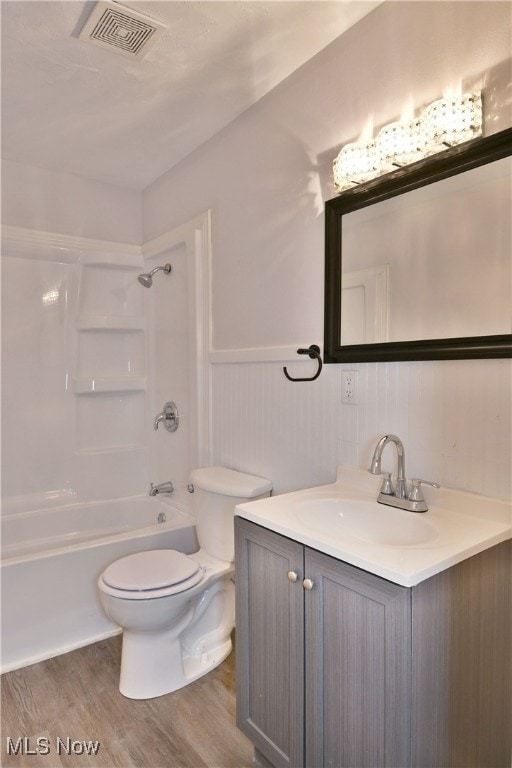 full bathroom featuring vanity, wood-type flooring, toilet, and shower / bath combination