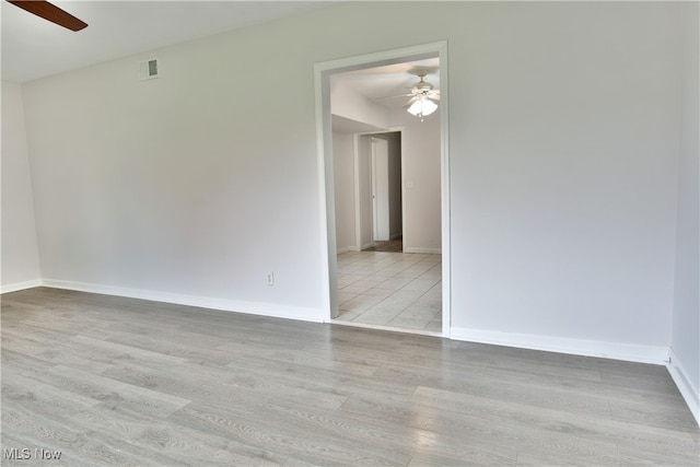 empty room with light hardwood / wood-style flooring and ceiling fan