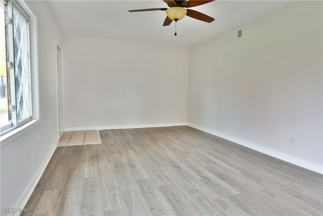 empty room with light hardwood / wood-style floors and ceiling fan