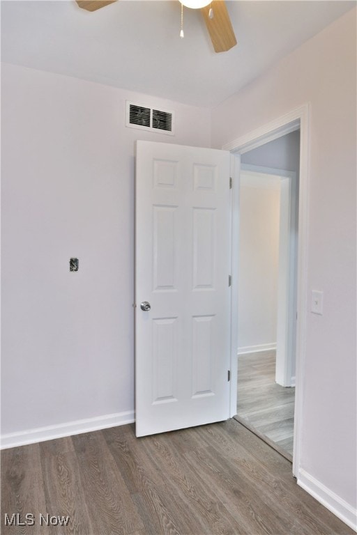 unfurnished bedroom with a closet, ceiling fan, and hardwood / wood-style flooring