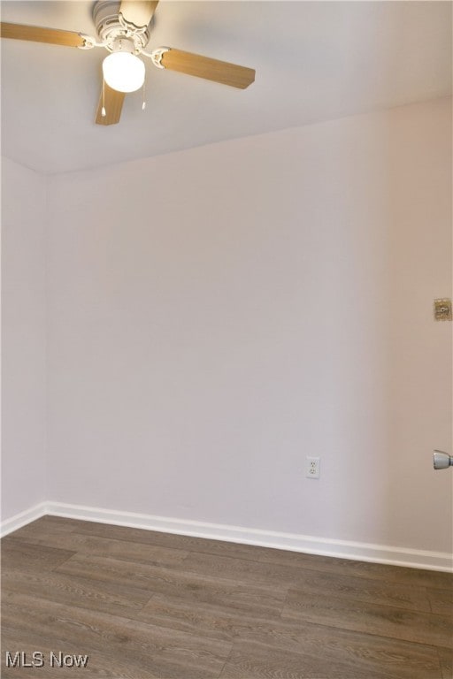 spare room with ceiling fan and dark hardwood / wood-style flooring