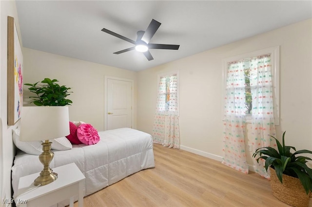 bedroom with ceiling fan and light hardwood / wood-style floors