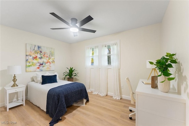 bedroom with wood-type flooring and ceiling fan