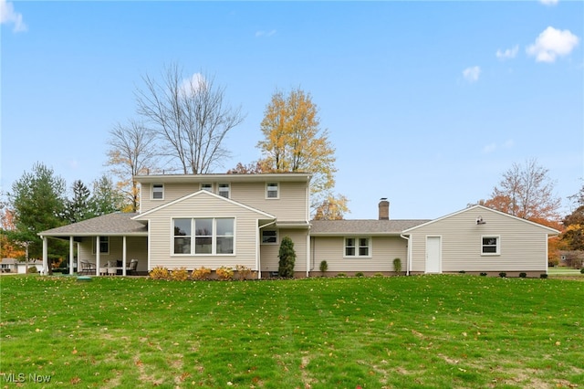 back of house featuring a lawn