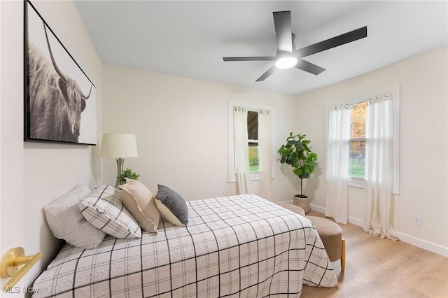 bedroom with ceiling fan and light hardwood / wood-style flooring