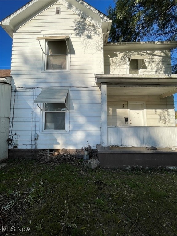 view of property exterior with a lawn