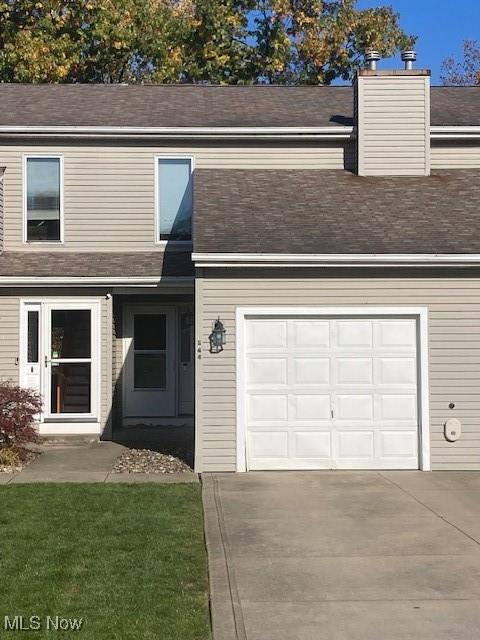 144 Maria Dr, Bedford, OH 44146 - view of front of house with concrete driveway, an attached garage, and a shingled roof