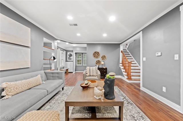 living room featuring ornamental molding and hardwood / wood-style flooring