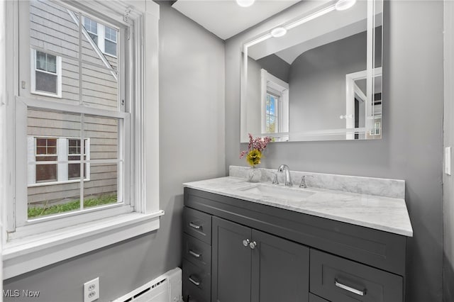 bathroom with vanity and a baseboard heating unit