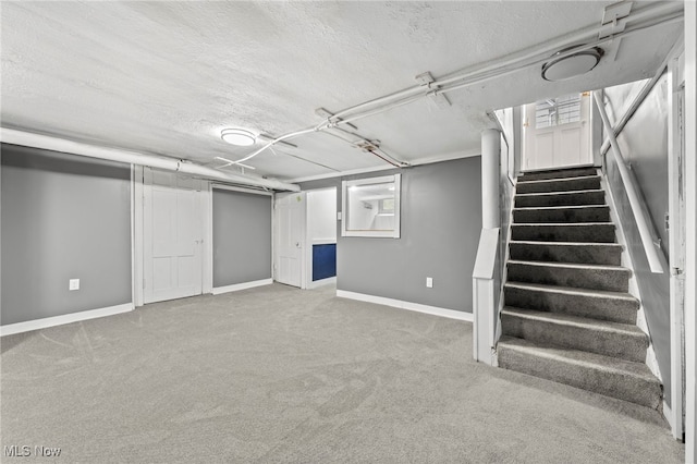 basement with carpet and a textured ceiling