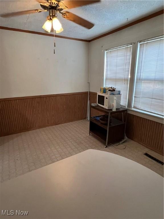 1208 N 4th St, Toronto, OH 43964 - home office with wainscoting, ornamental molding, ceiling fan, and wood walls