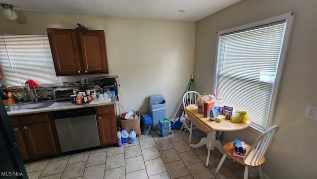 kitchen featuring stainless steel dishwasher and light tile patterned floors