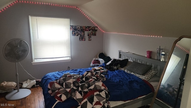 bedroom featuring lofted ceiling and hardwood / wood-style floors