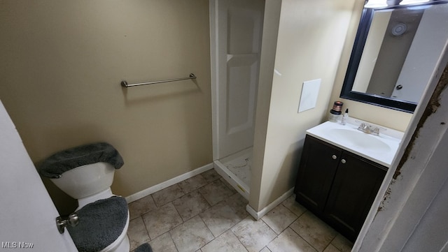 bathroom with vanity, toilet, and walk in shower