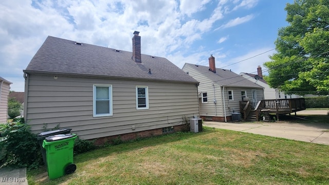 back of property featuring a patio area, cooling unit, a wooden deck, and a lawn