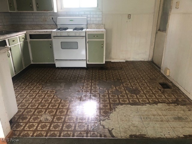 kitchen with sink, white gas range oven, and backsplash