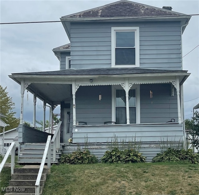 view of front of house featuring a front yard and a porch